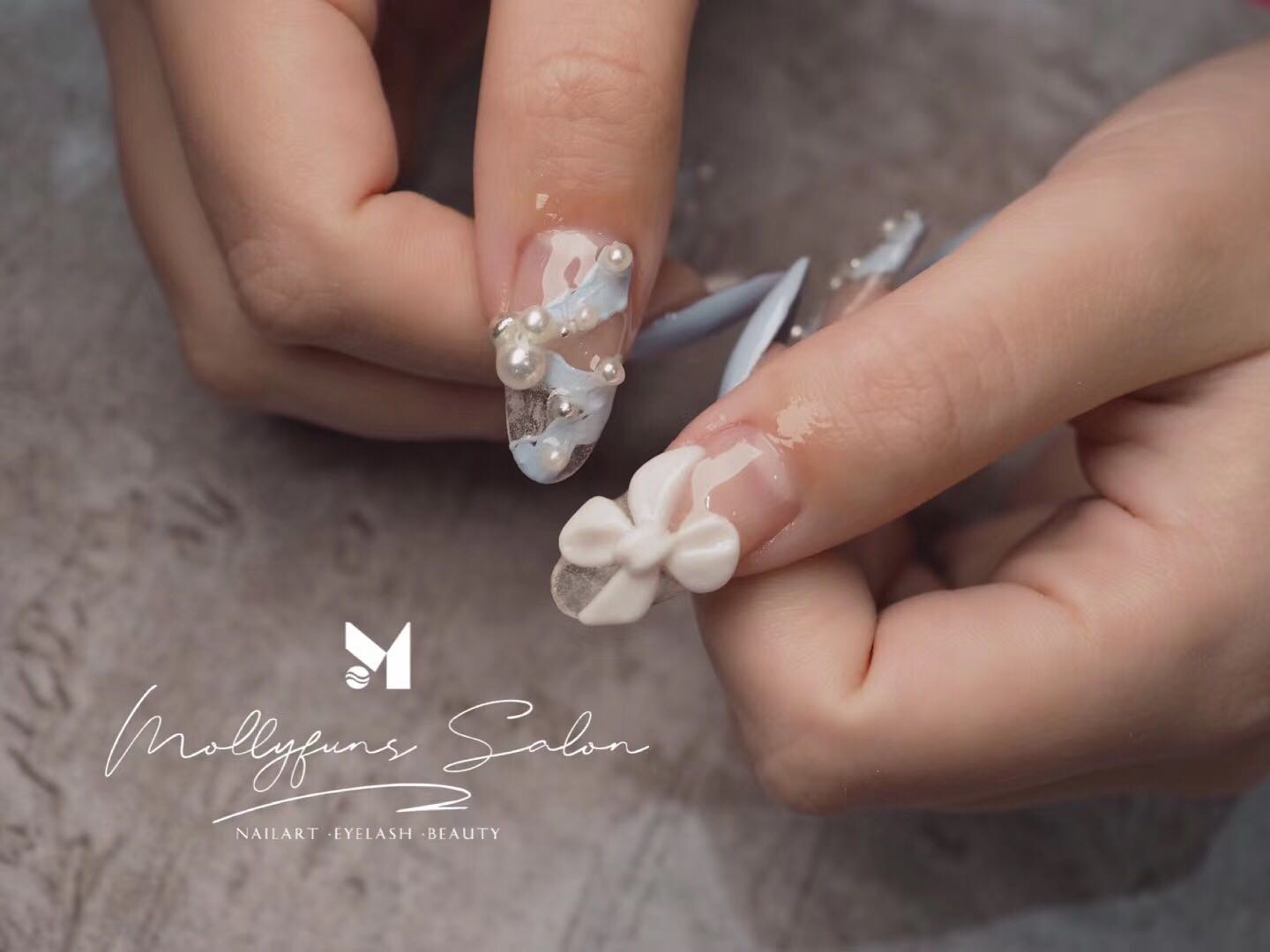 Press-on craft close-up with 3D white bow and pearls